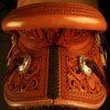 Wade tree, 15 inch seat, Gullet - 7 and 1/2 inch by 6 and 1/4 inch by 4 inch, Horn 4&1/2 inch round, 90 degree bars, 7/8ths full in-skirt riggin, Cheyenne Roll, Buckaroo outside leathers, half-breed Wade Saddle built and tooled with original floral and border design by Keith Valley.